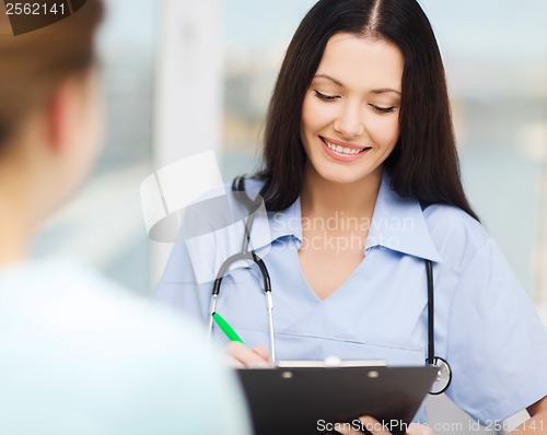 Image of smiling doctor or nurse with patient