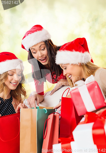 Image of women in santa helper hats with shopping bags