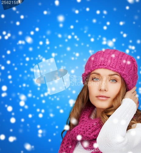 Image of woman in pink hat and scarf