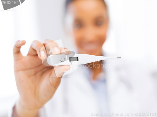 Image of female doctor holding thermometer