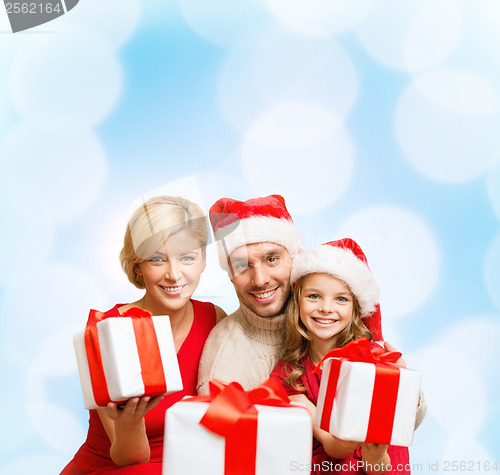 Image of smiling family giving many gift boxes