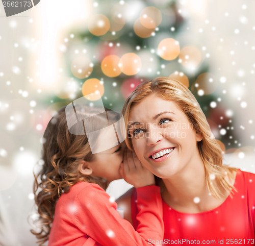 Image of mother and daughter whispering gossip