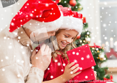 Image of smiling father and daughter opening gift box