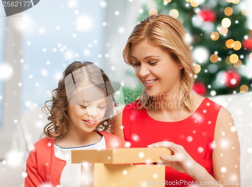 Image of happy mother and child girl with gift box