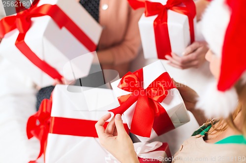 Image of three women holding many gift boxes