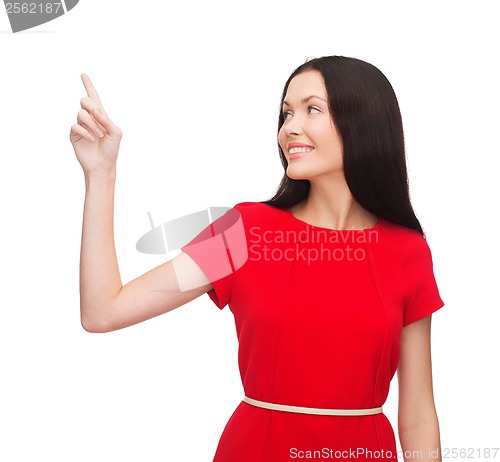 Image of young woman in red dress pointing her finger