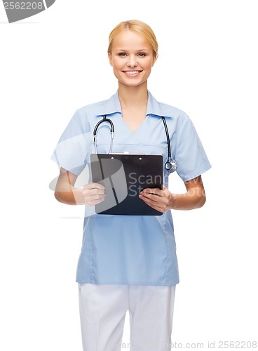 Image of smiling female doctor or nurse with clipboard