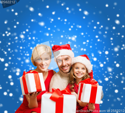 Image of smiling family giving many gift boxes