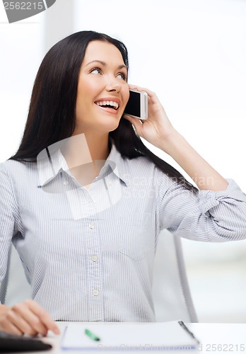 Image of smiling businesswoman or student with smartphone