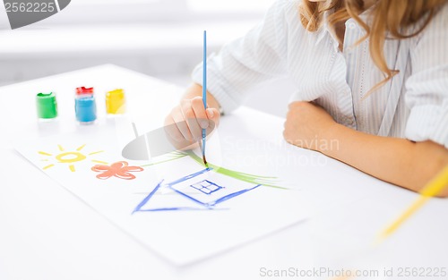 Image of little girl painting picture