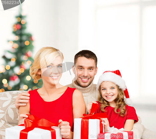 Image of smiling family holding many gift boxes