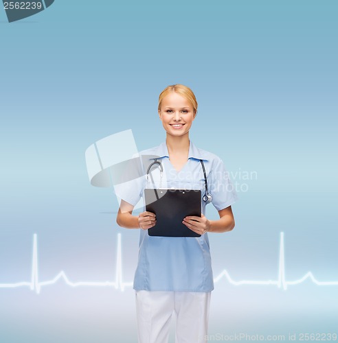 Image of smiling female doctor or nurse with clipboard