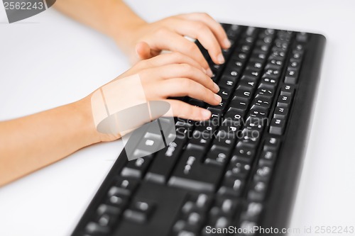 Image of student girls hands typing on keyboard