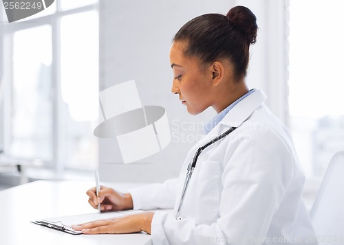 Image of female doctor writing prescription