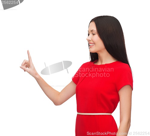 Image of young woman in red dress pointing her finger