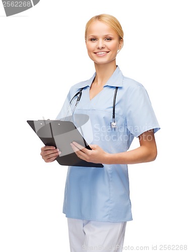 Image of smiling female doctor or nurse with clipboard