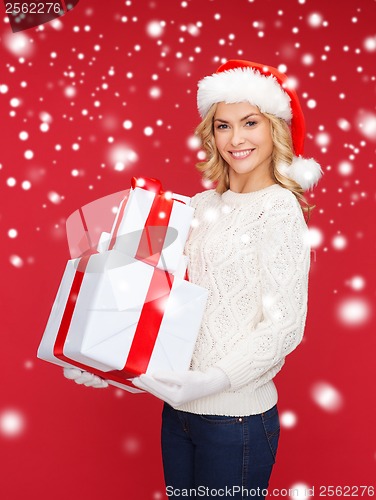 Image of woman in santa helper hat with many gift boxes