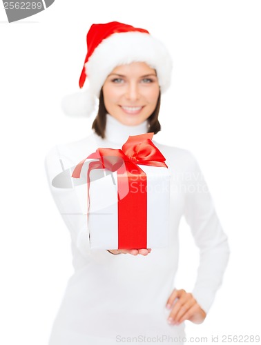 Image of woman in santa helper hat holding gift box
