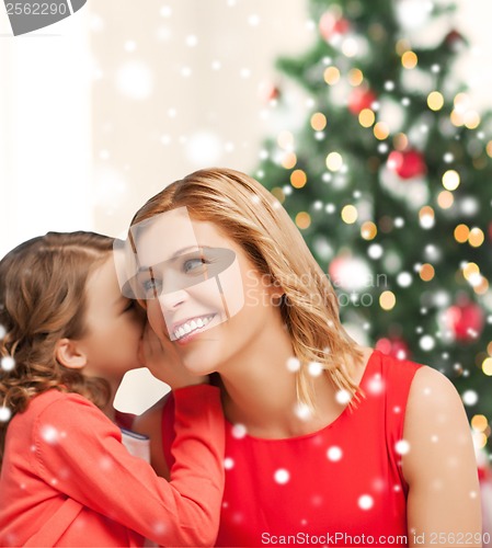 Image of mother and daughter whispering gossip
