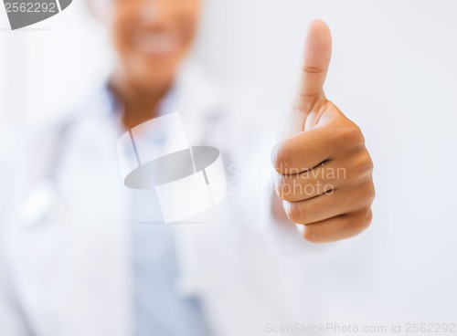 Image of female doctor showing thumbs up