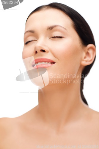 Image of smiling young woman with closed eyes