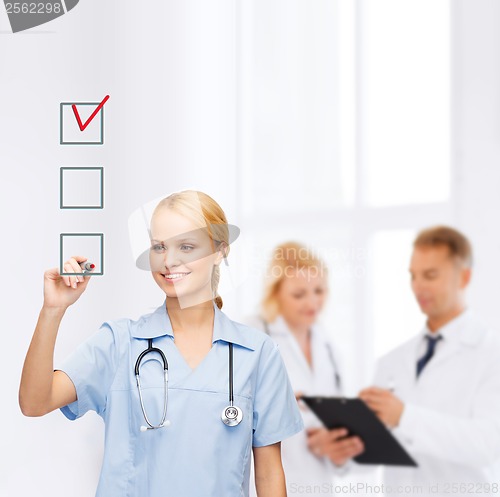 Image of doctor or nurse drawing checkmark into checkbox