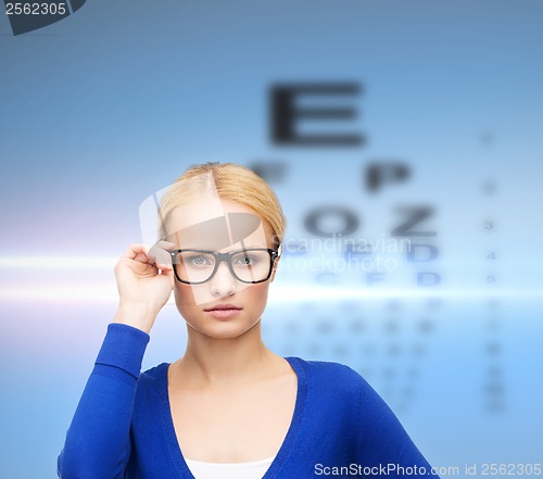 Image of smiling woman in casual clothes wearing eyeglasses