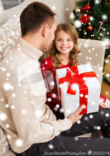 Image of smiling father and daughter looking at each other