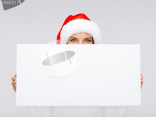 Image of woman in santa helper hat with blank white board