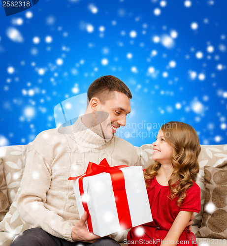 Image of smiling father and daughter looking at each other