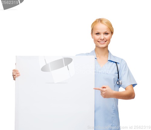 Image of smiling female doctor or nurse with blank board