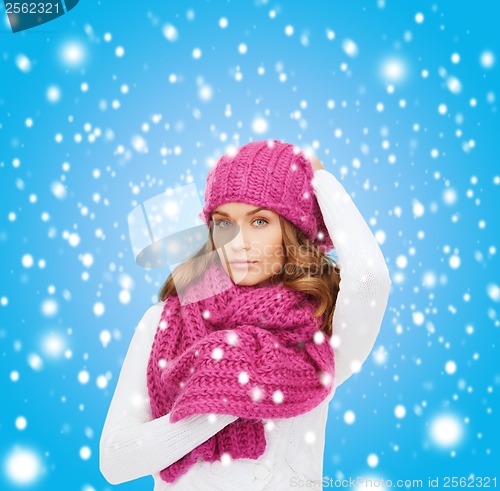 Image of woman in pink hat and scarf