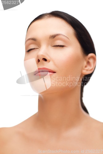 Image of relaxed young woman with closed eyes
