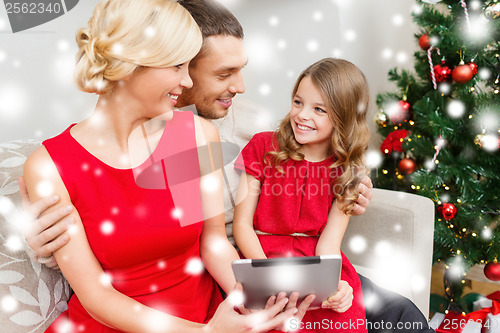 Image of smiling family with tablet pc