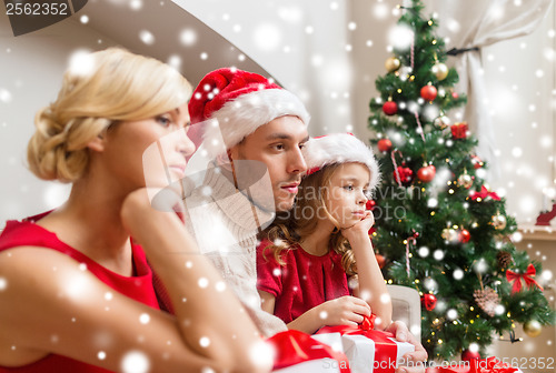 Image of depressed family at home with many gift boxes