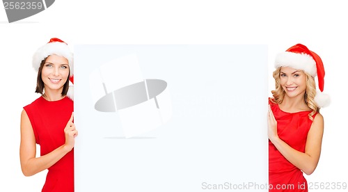 Image of woman in santa helper hat with blank white board