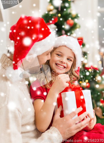 Image of smiling father and daughter opening gift box