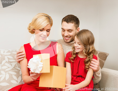 Image of happy family opening gift box