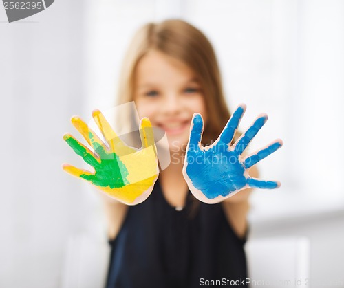 Image of girl showing painted hands