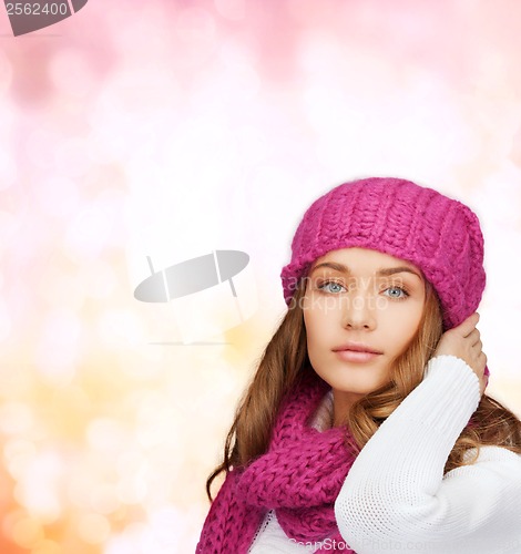 Image of woman in pink hat and scarf