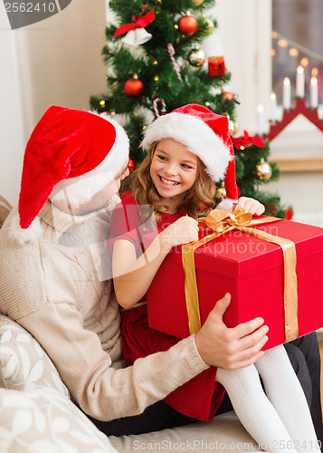 Image of smiling father and daughter opening gift box