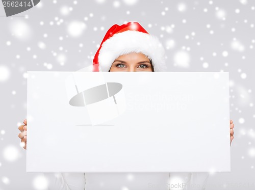 Image of woman in santa helper hat with blank white board