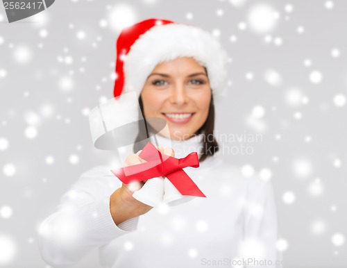 Image of woman in santa helper hat with jingle bells