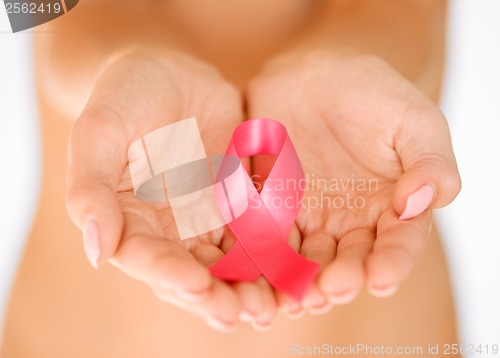 Image of hands holding pink breast cancer awareness ribbon