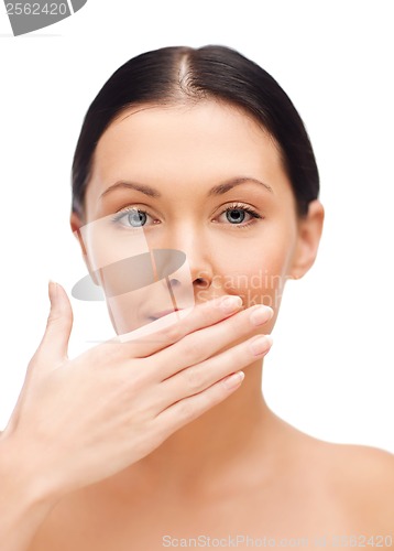 Image of beautiful woman covering her mouth