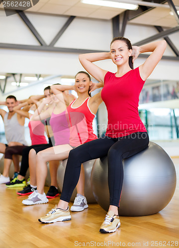 Image of group of people working out in pilates class