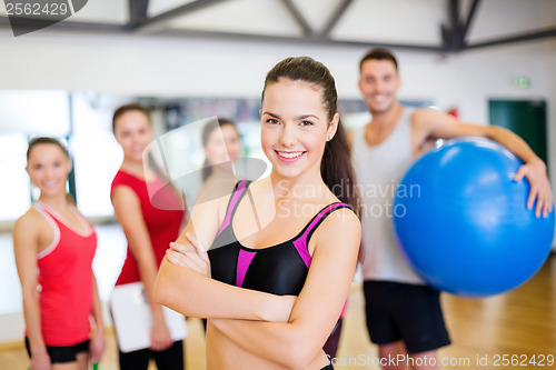 Image of woman standing in front of the group in gym