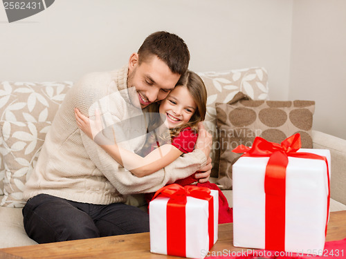 Image of smiling father and daughter hugging