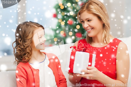 Image of happy mother and child girl with gift box