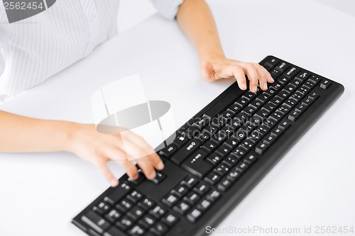 Image of student girls hands typing on keyboard